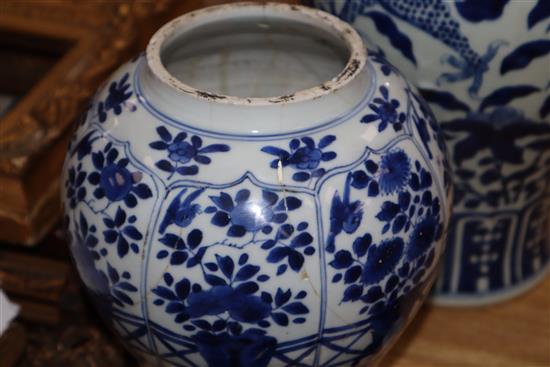 A large blue and white Chinese and a smaller similar vase with wooden cover, two stands and a cover